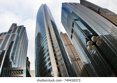 Modern Architecture Background.Chicago Downtown Upward Street View With The Willis (Sears) Tower Between Skyscrapers Against Blue Cloudy Sky. Travel America. Illinois, Midwest USA.Fish Eye Lens.