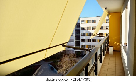 Modern architecture building facade with awnings. Balcony with awning opened, covered by sun-shield.  - Powered by Shutterstock