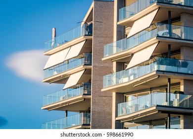 Modern Architecture Building Facade With Curtains, Awnings, Balcony, Glass, Windows