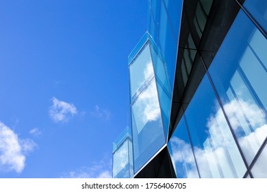 Modern Architecture Business Office Building Or Business Center With Glass Facade, Looking Up Skyscraper. Glass Facade With Blue Sky Reflection. Downtown. Concepts Of Financial, Economics, Future