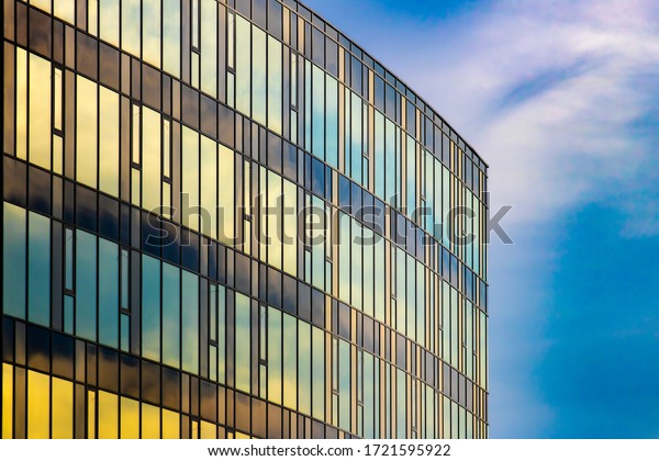 Modern architecture facade. Curtain wall facade\
of blue and yellow.