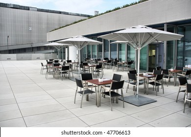 Modern architecture - fashionable outdoor cafe or restaurant tables in Munich, Germany