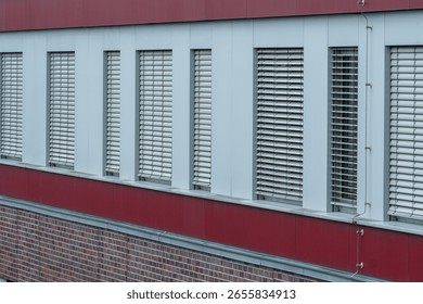 Modern architecture featuring rows of white venetian blinds on an office building, providing privacy and shade