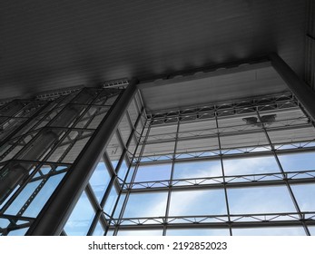 Modern Architecture. Structural Glazing Of Hi-tech Exterior. Minimal Office Building With Glass And Steel Wall View From Below. Real Estate, Financial Business And Construction Industry. Windows.