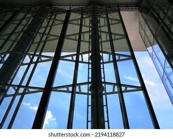 Modern Architecture. Structural Glazing Of Hi-tech Exterior. Minimal Office Building With Glass And Steel Wall View From Below. Real Estate, Financial Business And Construction Industry. Windows.