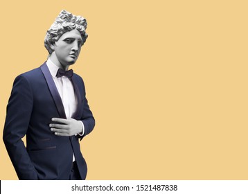 Modern Art Collage. Concept Portrait Of Handsome Stylish Man In Elegant Blue Suit .Gypsum Head Of Of Apollo. Man In Suit. 