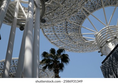 Modern artificial tree constructions and shopping street on Dubai Bluewaters Island.  Dubai, UAE, United Arab Emirates.
