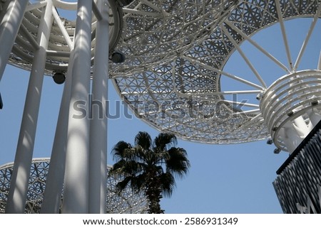 Modern artificial tree constructions and shopping street on Dubai Bluewaters Island.  Dubai, UAE, United Arab Emirates.