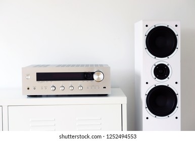 Modern Audio Stereo System With White Speakers On Bureau In Modern Interior