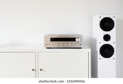 Modern Audio Stereo System With White Speakers On Bureau In Modern Interior