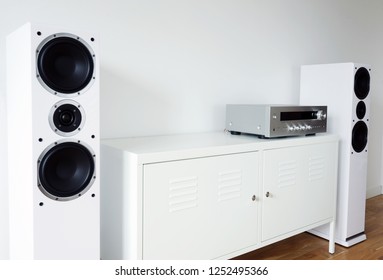 Modern Audio Stereo System With White Speakers On Bureau In Modern Interior