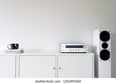 Modern Audio Stereo System With White Speakers On Bureau In Modern Interior