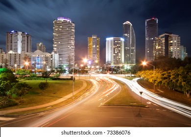 Modern Australian City At Night With Moving Clouds In Background And Traffic Car Lights In Foreground (broadbeach,gold Coast,qld,australia)