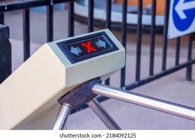 Modern automated metallic turnstile entrance system with stop sign on it means closed pass. Forbidden access for enter and exit through the tourniquet