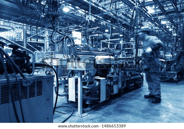 Modern automatic\
automobile manufacturing workshop. A busy car production line.\
Industrial scenery\
background.