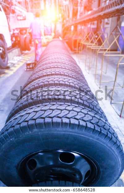 Modern\
automatic automobile workshop. Rows of car tires waiting to be\
installed. Industrial scenery\
background.