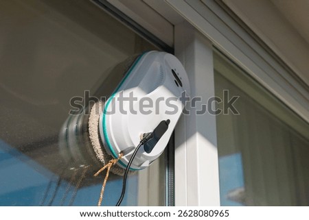 A modern automatic device, a vacuum robot window cleaner, cleans glass from dirt and streaks with safety from falls from a height. 