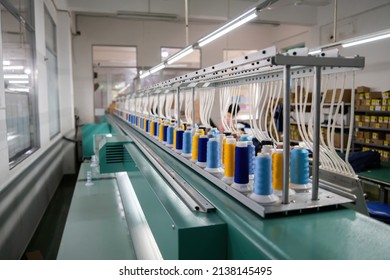 Modern and automatic high technology embroidery machine for textile or clothing apparel making manufacturing process in industrial. Close up Computerized embroidery machines. Digital textile industry.