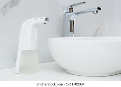 Modern Automatic Soap Dispenser Near Sink In Bathroom, Closeup