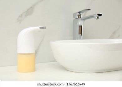 Modern Automatic Soap Dispenser Near Sink In Bathroom, Closeup