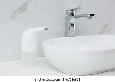 Modern Automatic Soap Dispenser Near Sink In Bathroom, Closeup