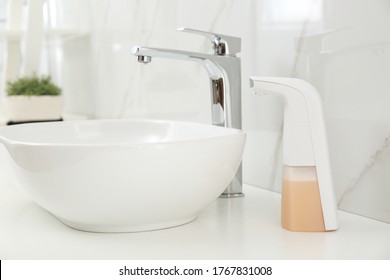 Modern Automatic Soap Dispenser Near Sink In Bathroom, Closeup