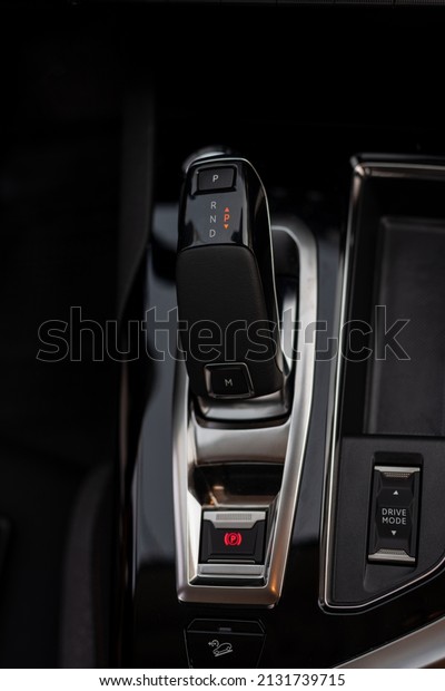 Modern automatic\
transmission parked inside the interior of a modern vehicle. Soft\
selective focus.