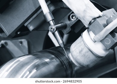 Modern automatic welding machine for welding metal pipes, industrial welding concept background.