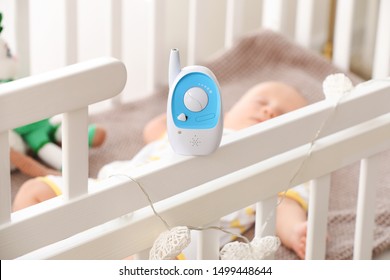 Modern Baby Monitor On Crib Of Sleeping Infant