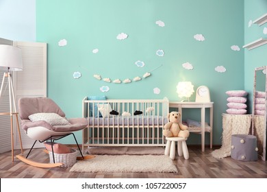Modern Baby Room Interior With Crib And Rocking Chair