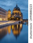 The modern backside of the City Palace, the cathedral and the river Spree in Berlin at dusk