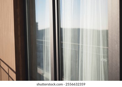 A modern balcony adorned with sheer curtains and offering a scenic view - Powered by Shutterstock