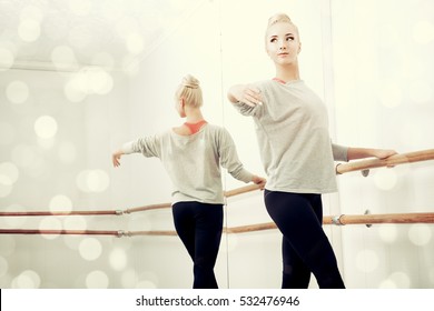 Modern ballet dancer in a ballet class. Sepia toned photo.