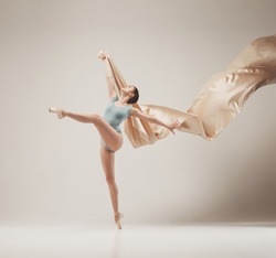 Modern ballet dancer dancing in full body on white studio background, a ...