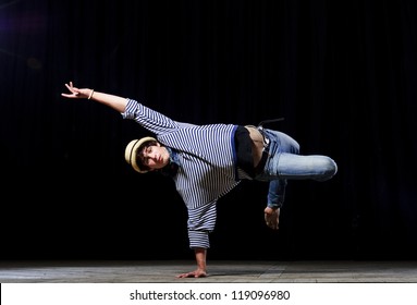 Modern Ballet Style Male Dancer Performs On High Lighted Stage .