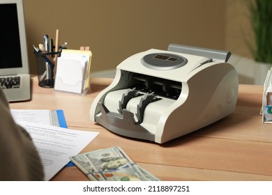 Modern Banknote Counter On Wooden Table Indoors