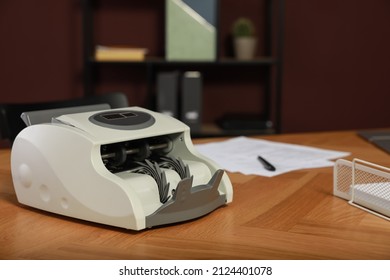 Modern Banknote Counter On Wooden Table Indoors