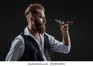 Modern barbershop haircut. Bearded hipster barber isolated on black. Man beard haircut by hairdresser at barbershop. Handsome barber using retro blade while cutting hair. Precision haircut - Powered by Shutterstock