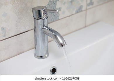 Modern bathroom chrome faucet with running water