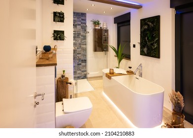 Modern bathroom with freestanding bathtub, modern taps and LED ambient lighting - Shutterstock ID 2104210883