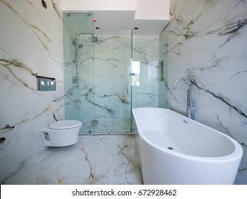 Modern Bathroom Interior With Bathtub And Glass Shower Enclosure