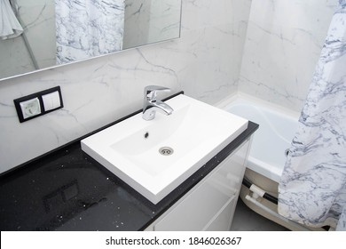 Modern Bathroom Interior, Marble Tiles, Mirror, Jacuzzi, White Vanity Unit.