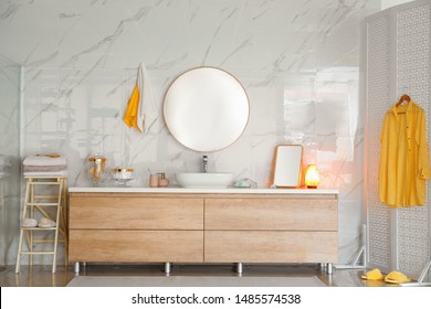 Modern Bathroom Interior With Vessel Sink And Round Mirror