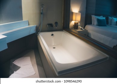 Modern Bathroom Interior With White Bathtub In Low Light Style. (Night Shoot Photo)