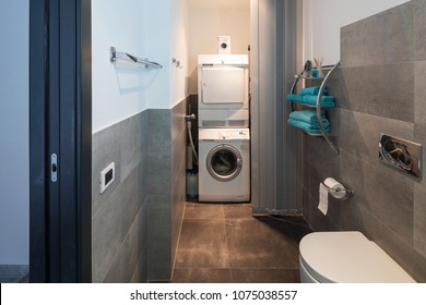 Modern Bathroom With Large Tiles With Washer And Dryer