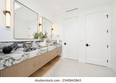 Modern bathroom with marble countertop, dual sinks, and elegant lighting in a bright, minimalist design. - Powered by Shutterstock