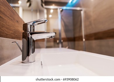 Modern Bathroom Sink Faucet Closeup Photo.