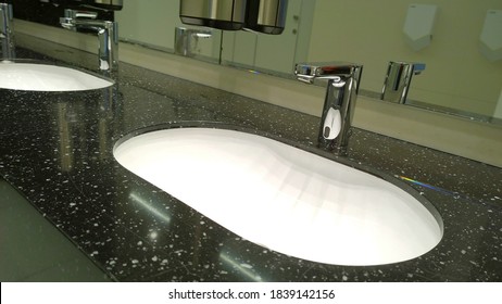 Modern Bathroom Sink And Faucet In Public Toilet And Restroom. Touchless Taps. Virus Protection Concept. Sanitary Rules And Requirements. Contemporary Washroom And Wc In Office Centre. Hygiene.