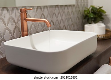 A Modern Bathroom Sink Minimalist Design, White Sink And Slow Running Clean Water From The Faucet