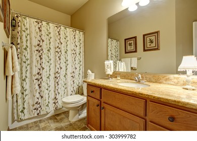 Modern Bathroom With Tile Floor, And Decorative Shower Curtain.